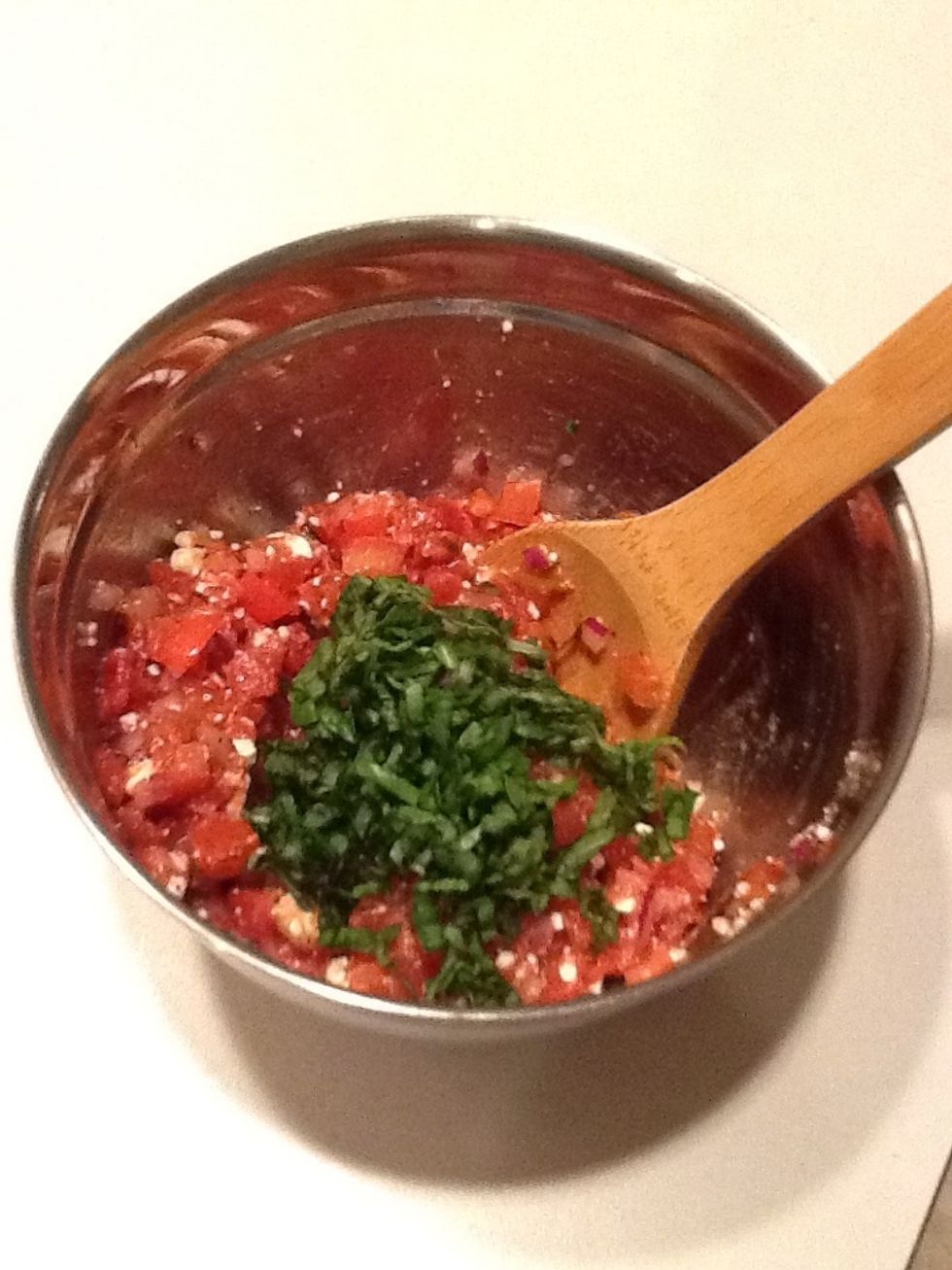 Remember the basil you chopped earlier that made your kitchen smell so delightful? Time to add that to the mix. Fold carefully to blend.