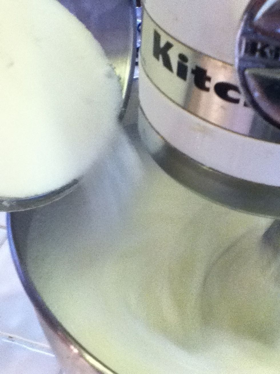 Remember the other half of that sugar? Gradually pour it in with the egg whites. Continue to beat for about 5 minutes until soft peaks form.