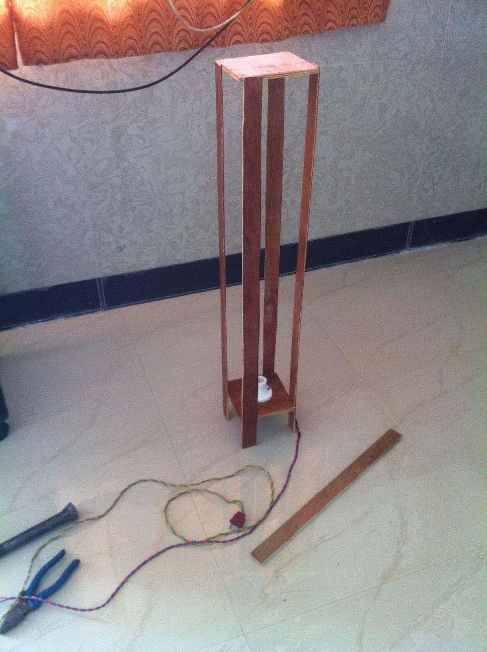 Remember to fix strips diagonally after fixing all 4 strips it will look like this.. Now wrap a tress paper or thin handmade paper over it. You may you white cloth too instead of paper.