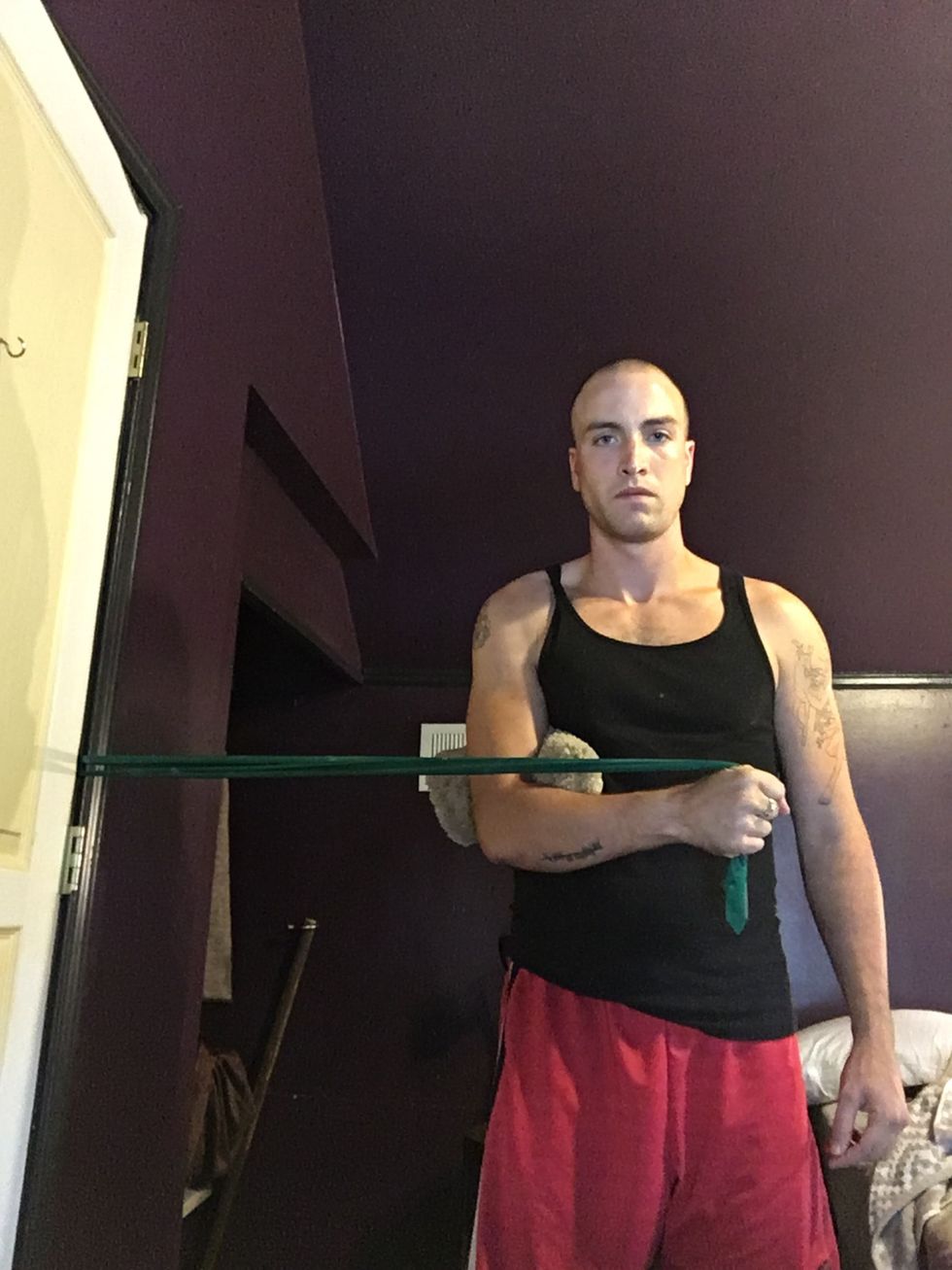 Remember to keep your elbow tucked in, and finish when your fist touches your stomach. Release slowly to increase strength in your shoulder, using the resistance.
