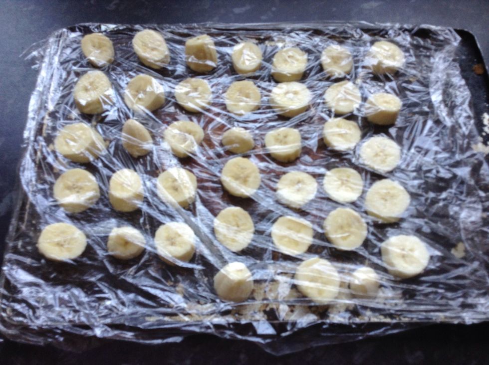 Remember when we didn't cut the cling film off. Now we need to fold it back over the top so the slices are covered up.