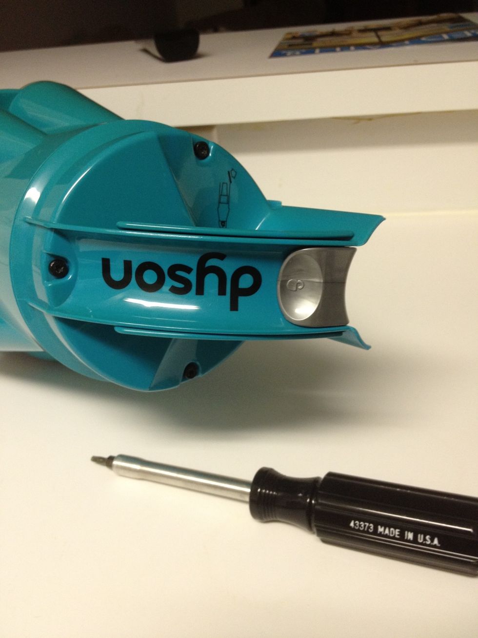 Remove 3 screws with screwdriver. Pull up gently to remove handle and rod from cyclone attachment.