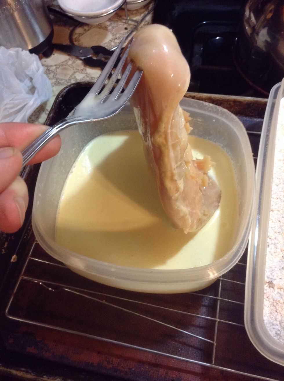 Remove a piece of chicken from pickle juice and place in wet mixture and coat both sides.