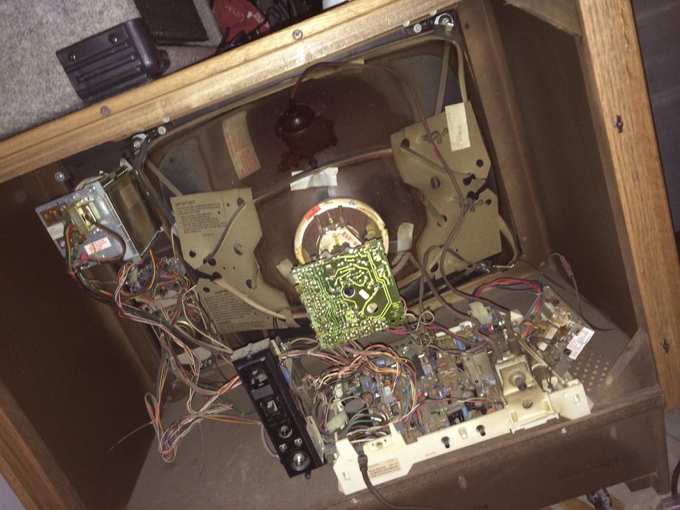 Remove all electronics/guts of the tv. Be careful not to chip the wood that some parts are mounted to.