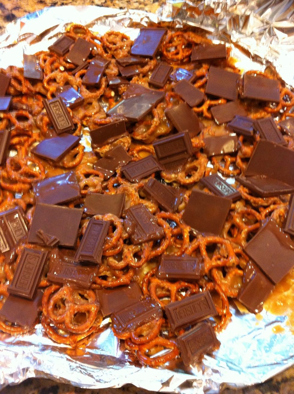 remove and turn the oven OFF. Break up Hershey bars (about 5-6 bars) and lay over pretzels. The heat from pretzels will melt the choc some, but I put this back in the OFF oven for another minute