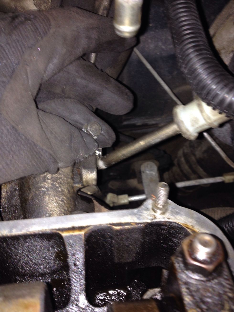 Remove bolt securing "---" line. - 10mm socket