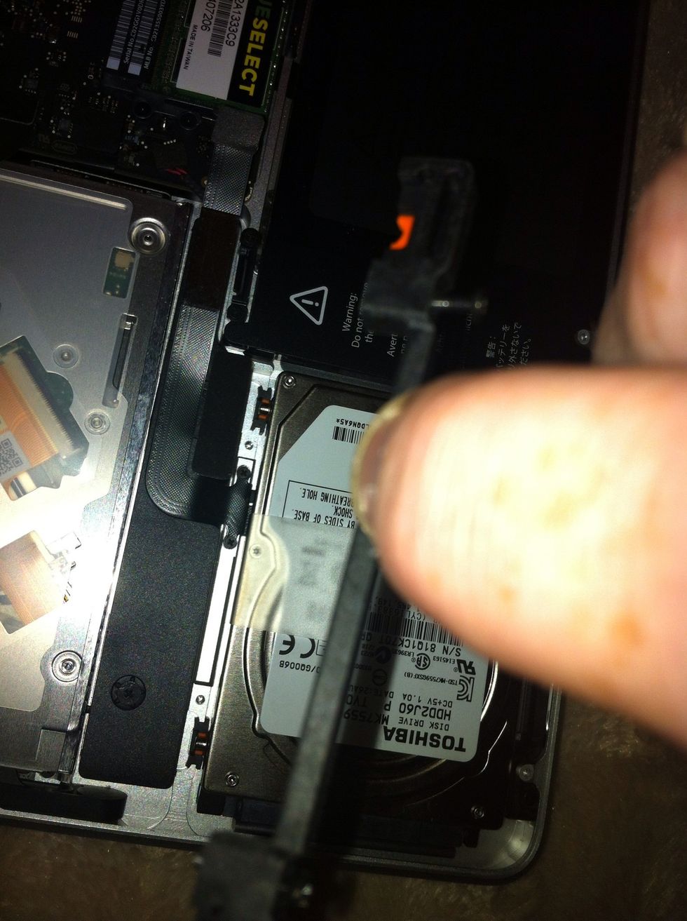 Remove bracket on left of hard drive.  Bracket on right jus unscrew to release this bracket stays in place