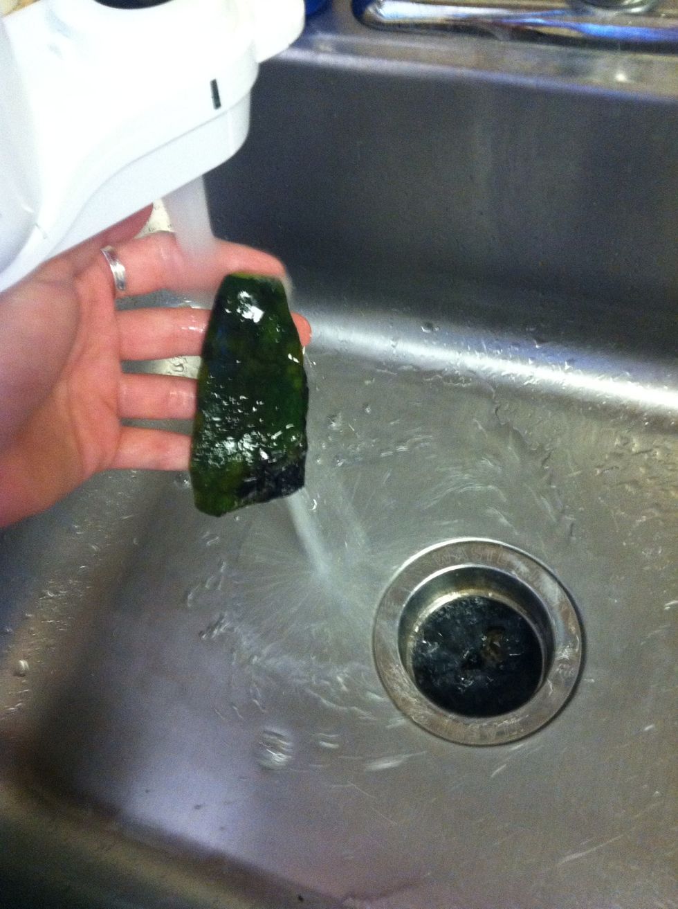 Remove burnt part of pepper under cold water