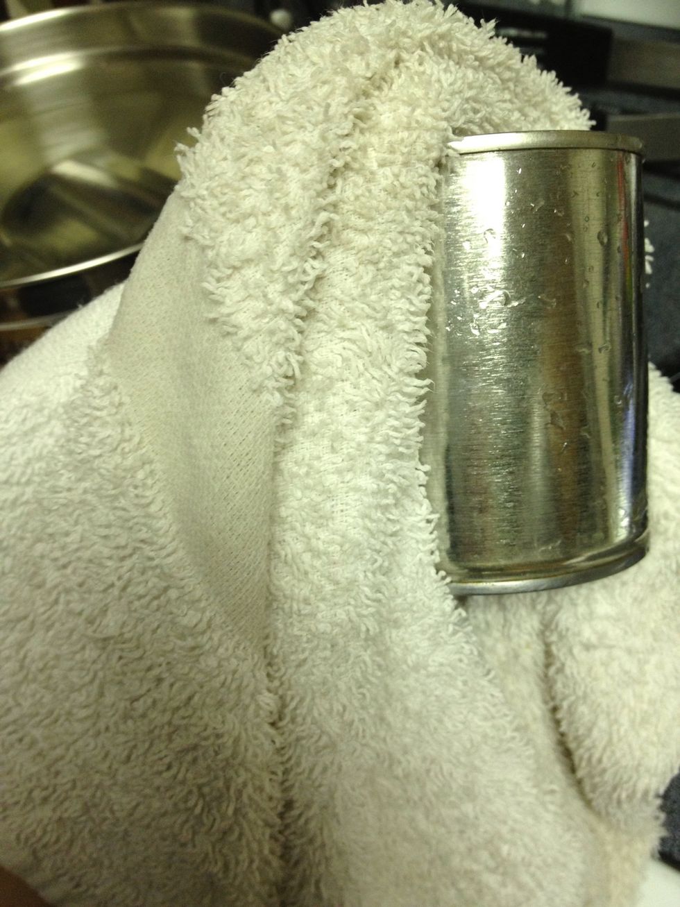 Remove cans from water and dry them so they won't be slippery.
