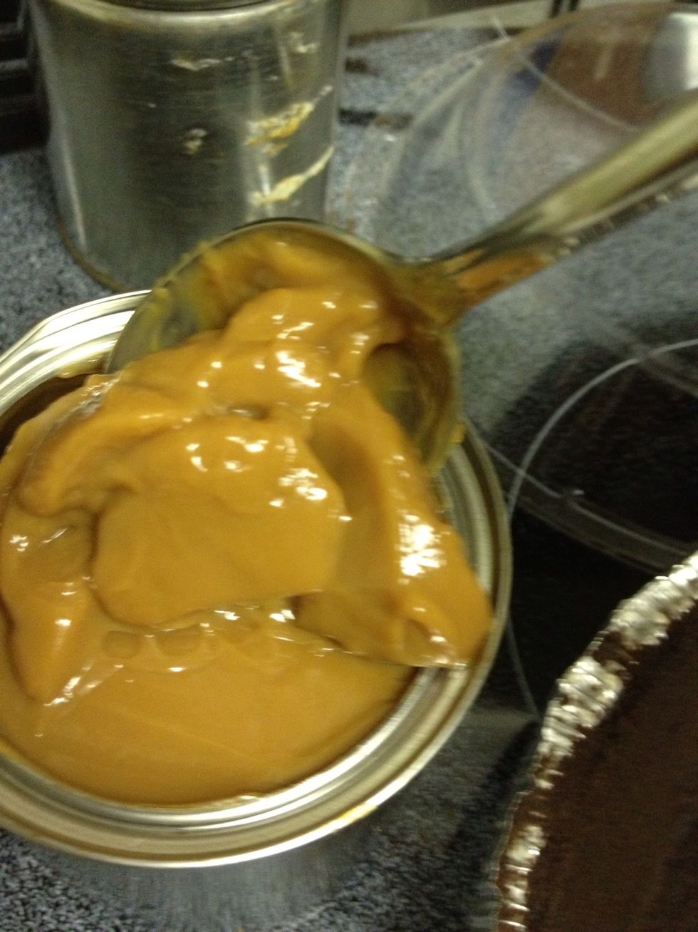Remove caramelized, sweetened milk from can with spoon. Empty the caramel into a medium-sized bowl.