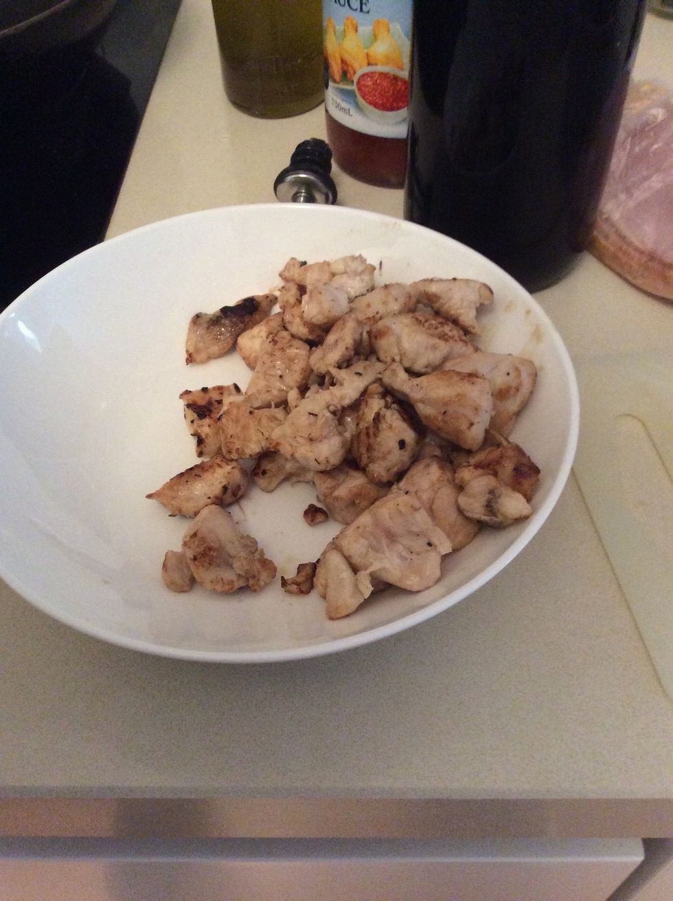 Remove chicken from wok and place it in bowl.