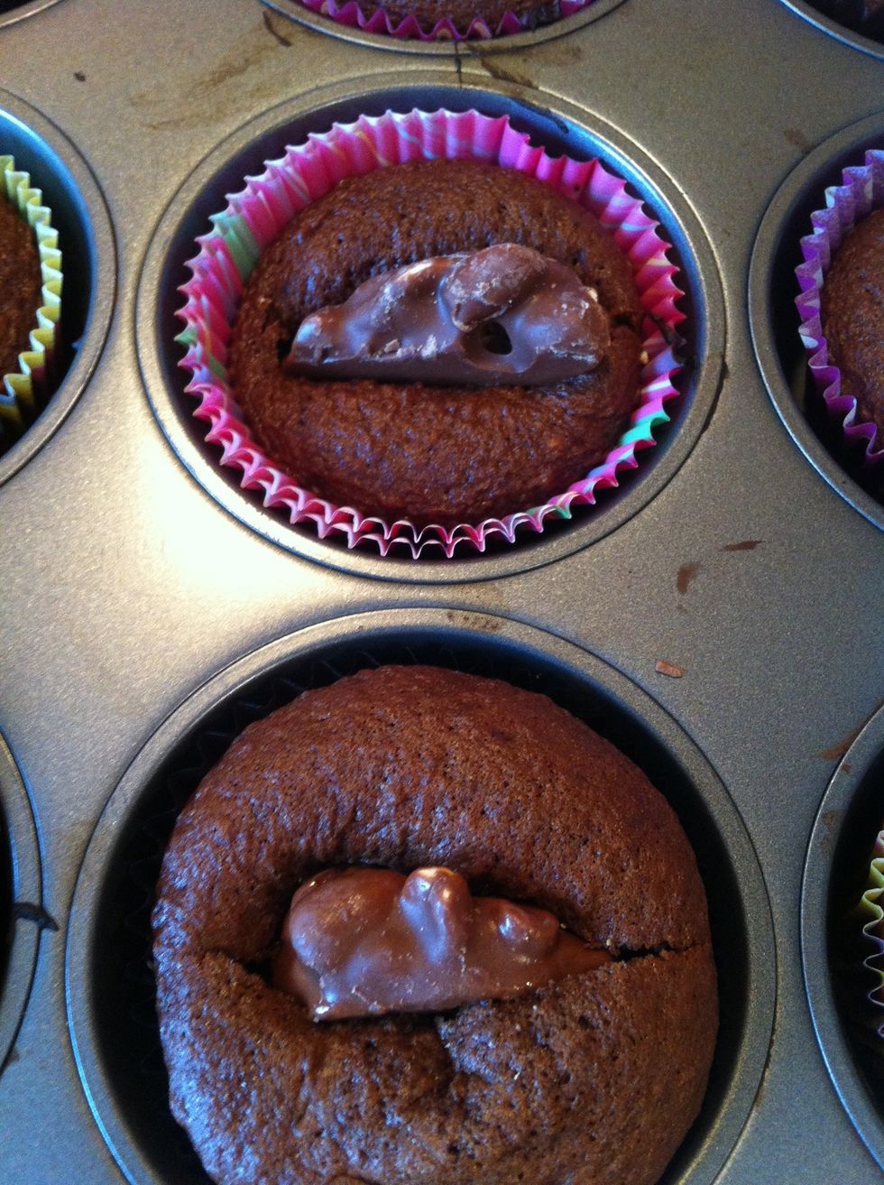 Remove cupcakes from oven. Use a sharp knife to cup a slit in the top of the cupcake. Push the turtle chocolate into the cupcake as far as it will go. Bake for an additional 4 minutes.