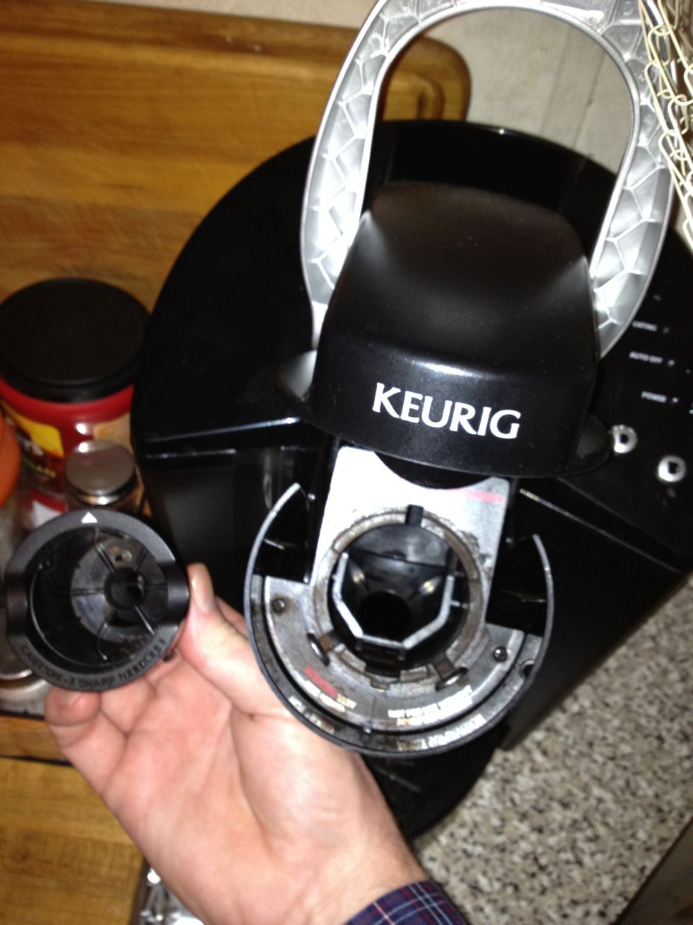 Remove default filter by covering the bottom hole and giving a firm upward push while holding on to the open compartment, preventing closure.