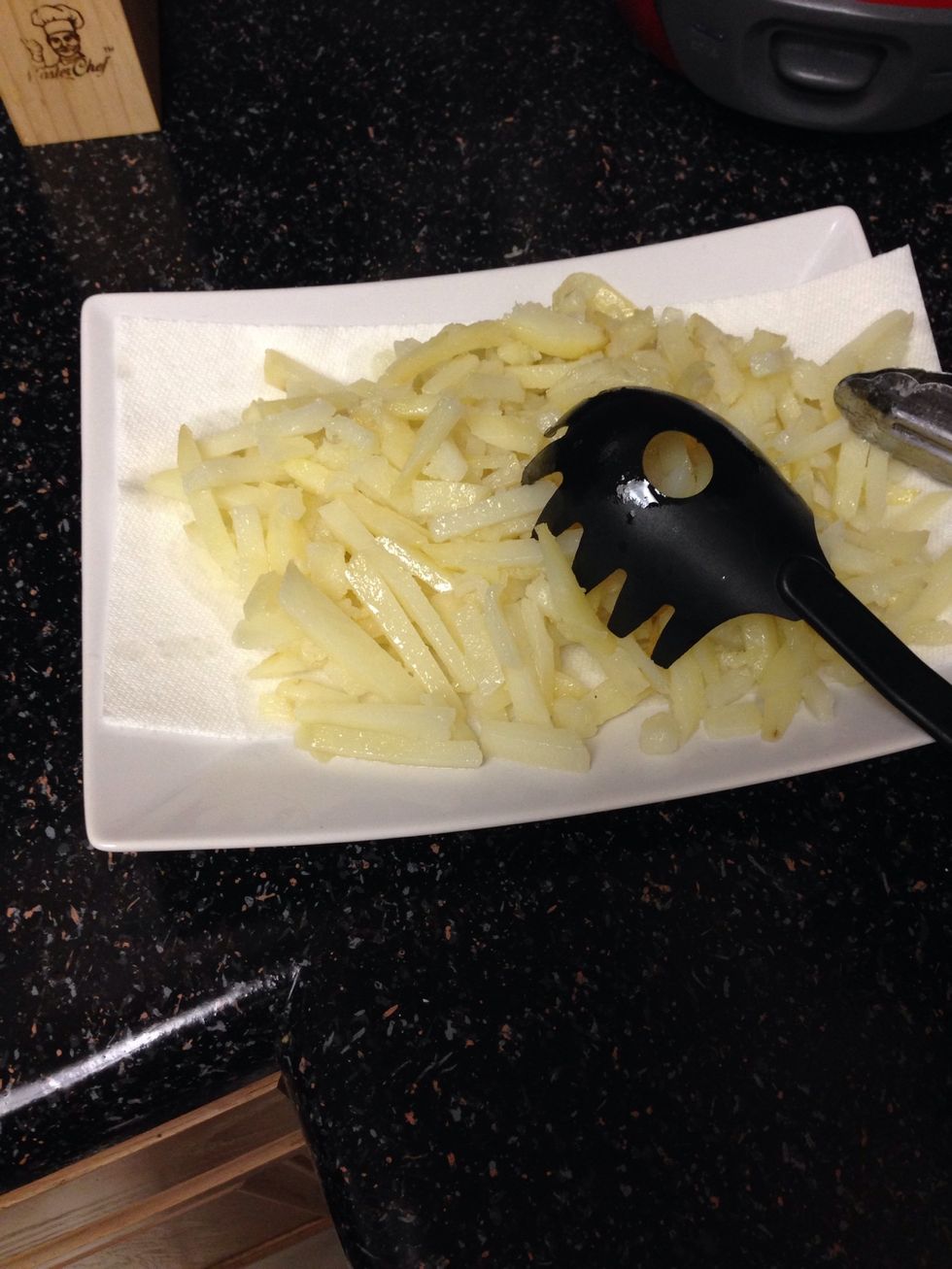 Remove fries onto a paper towel as they'll cool down and turn the heat now to high. Which will actually fry the fries. Careful while removing the fries as they will be soft.