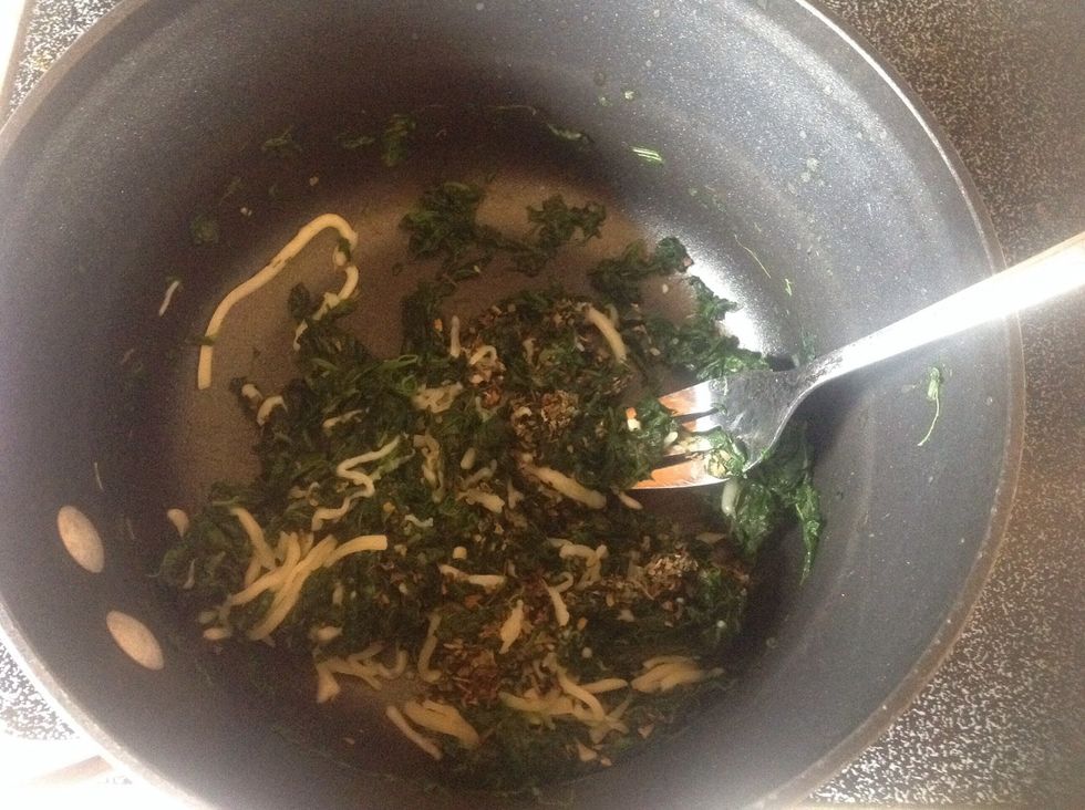 Remove from heat , add the basil and 1/2 the mozzarella cheese.