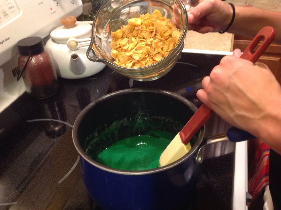 Remove from heat. Stir in the food coloring, vanilla, and cornflakes.