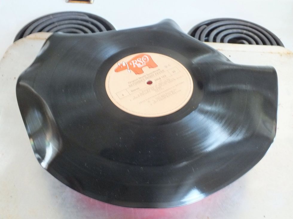 Remove from oven. Using a pencil or similar object push the record down into the bowl. It should be quite soft and fold nicely. Allow to cool for a minute or so. Doesn't take long.