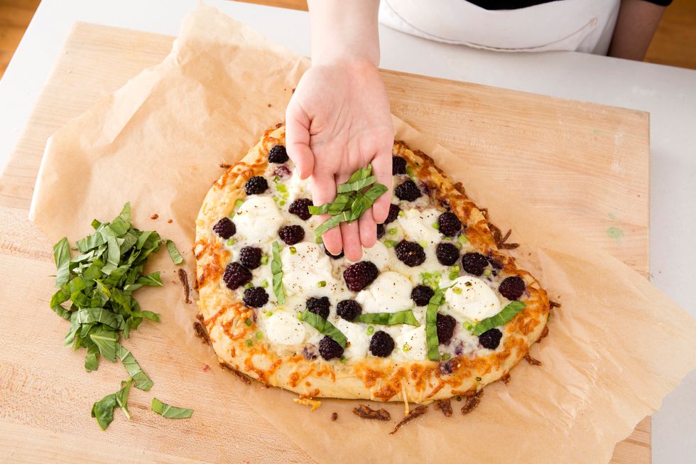 Remove from the oven and immediately add your basil.