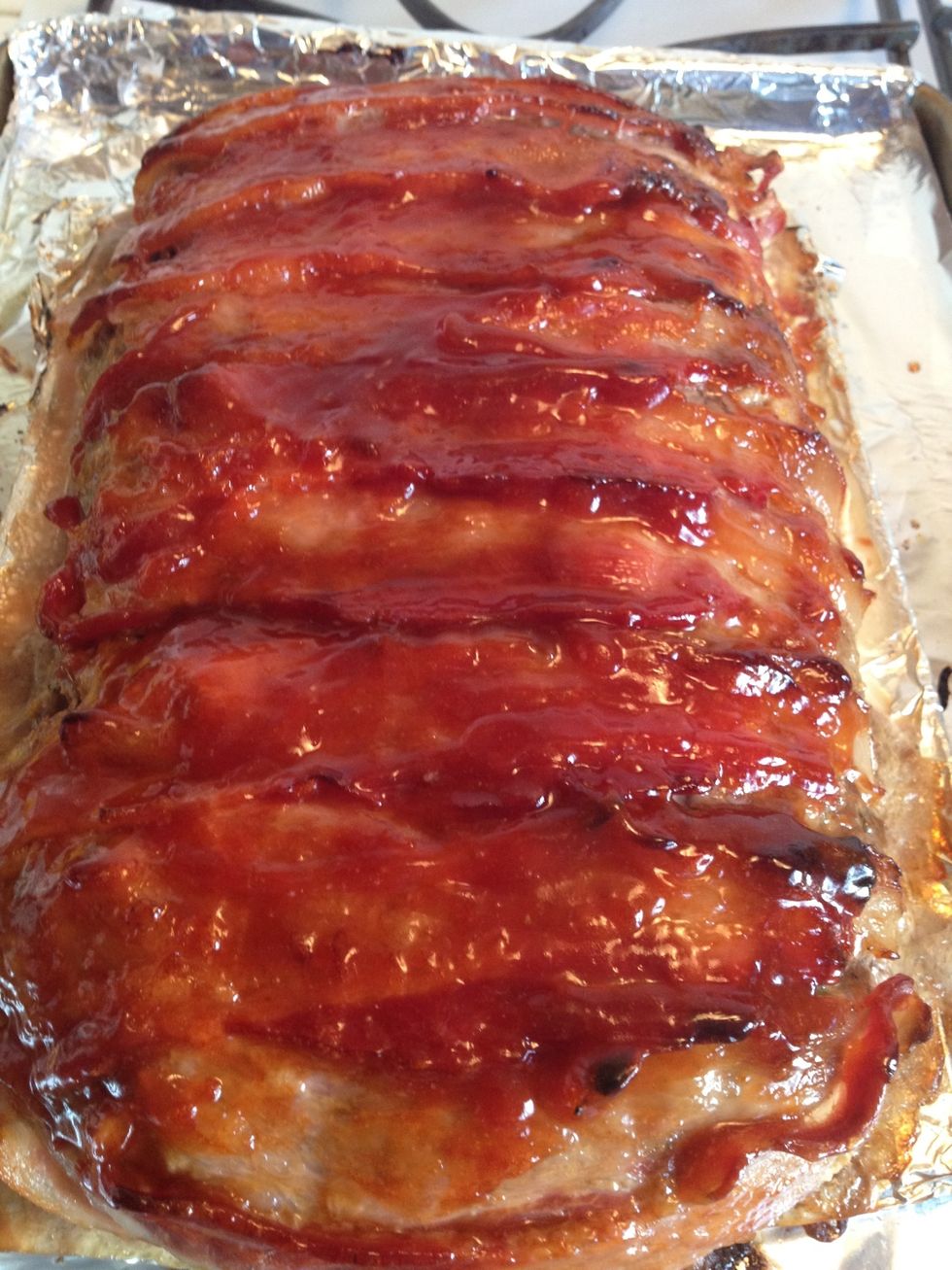 Remove from the oven and put on another one-third of the sauce over the meatloaf. Use a brush or a rubber spatula this time to spread it. Bake an additional 20-25 minutes.
