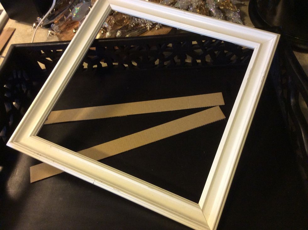Remove glass and backing from picture frame. Cut 2 strips of cardboard or wood to fit inside frame from the back.