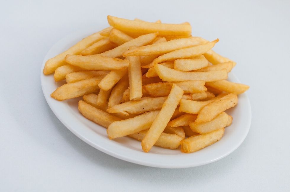 Remove hot chips from oven and place on the plate.