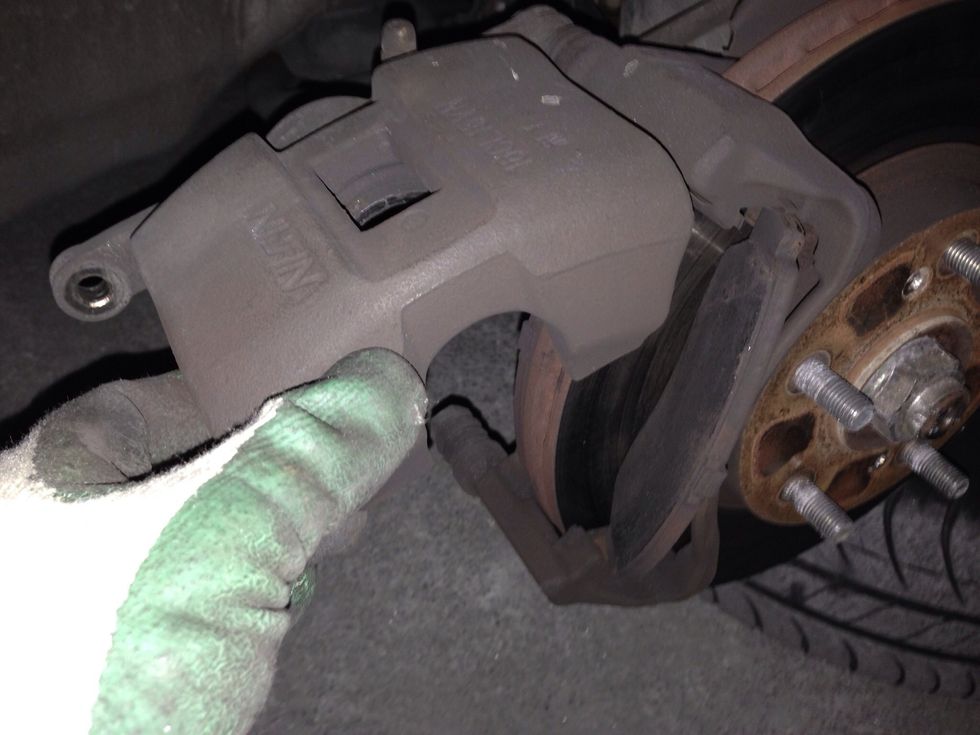 Remove lower screw/pin from caliper and turn it up. Remove used brake pads. MEMORIZE which was inside and out.