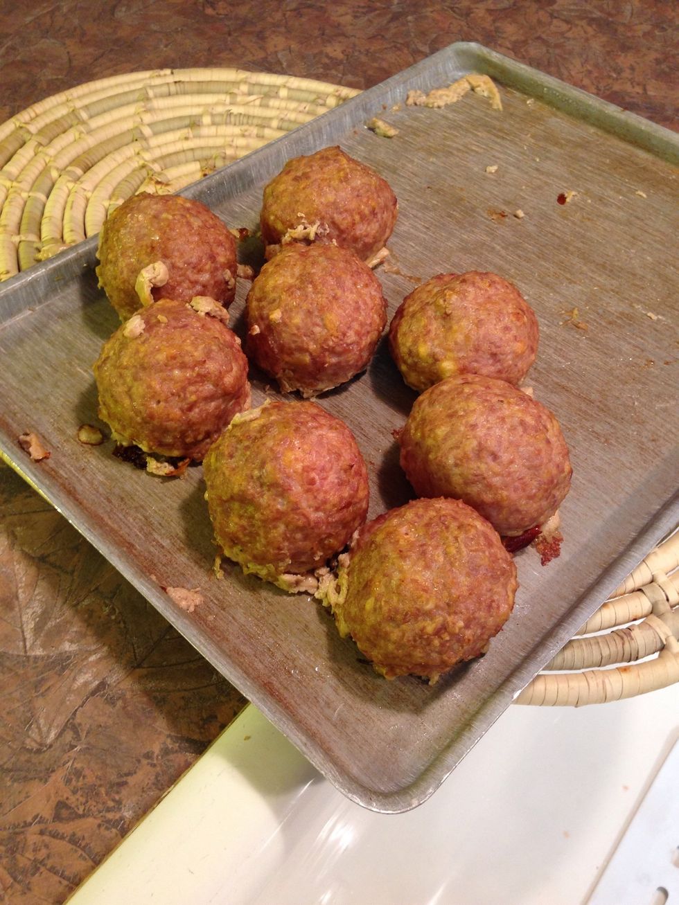 Remove meat/egg balls when pork is evenly browned. Cool on wire rack 10 minutes. Reduce oven to 375\u00b0.