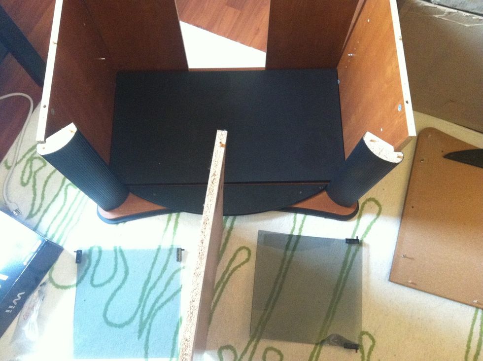 Remove middle piece. Careful: glass doors will fall