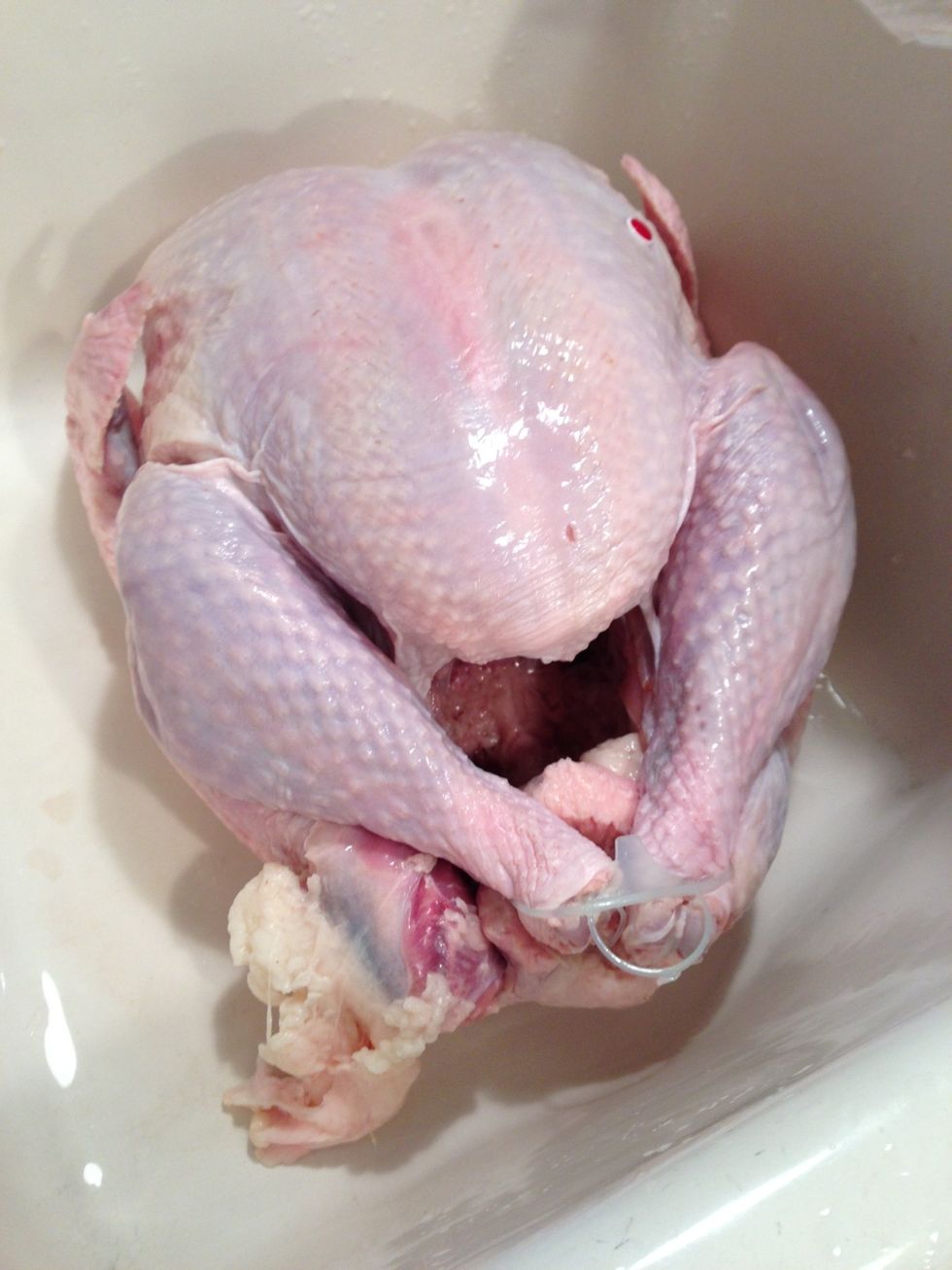 Remove neck, and bag of giblets. Wash turkey inside & out. Using a spoon, scrape any remaining membrane from inside along rib cage.