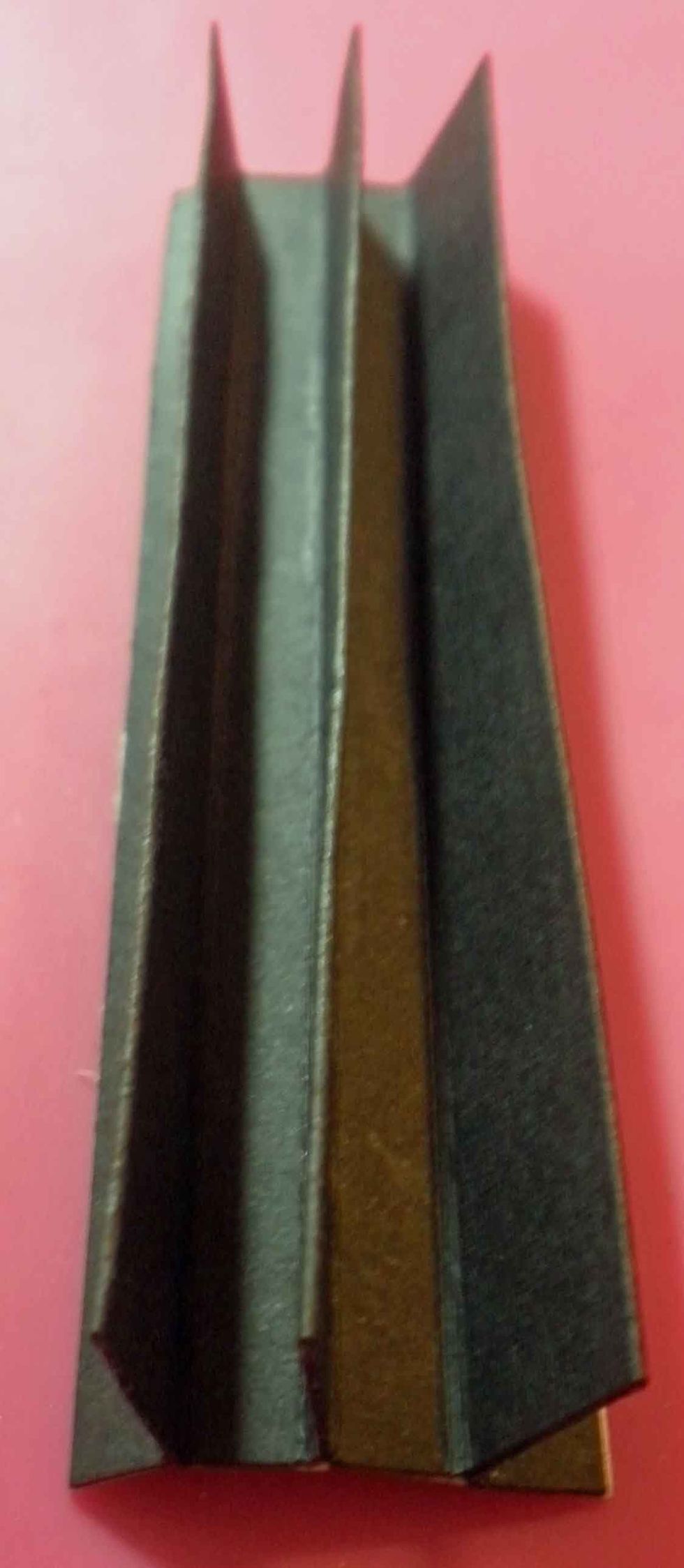 Remove only the \u00bd" strips and fold the two \u00bd" sections together. This will give you a hinge that will hold three pages, as shown.