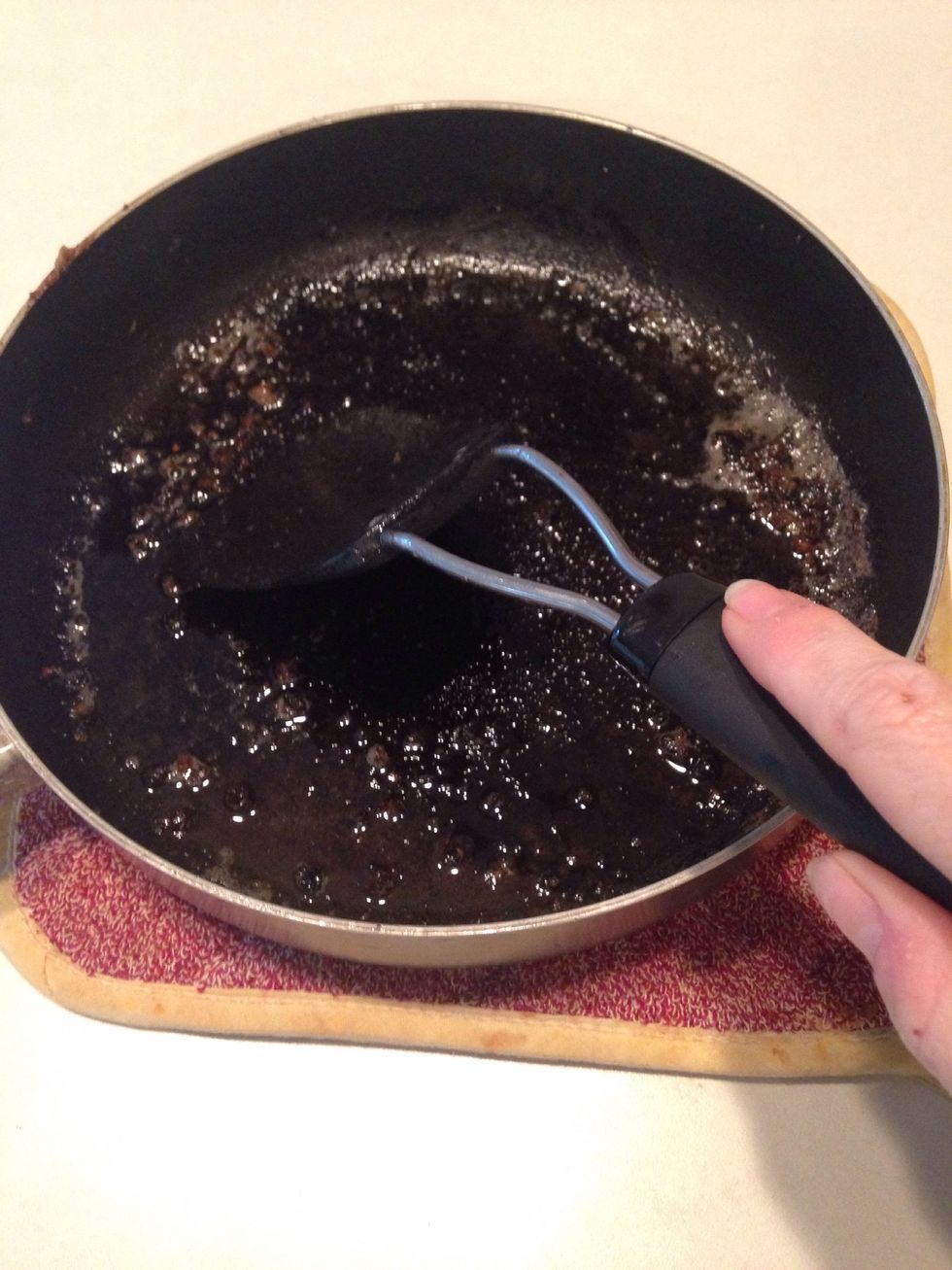 Remove pan from burner and scrape browned bits of meat with a spatula.