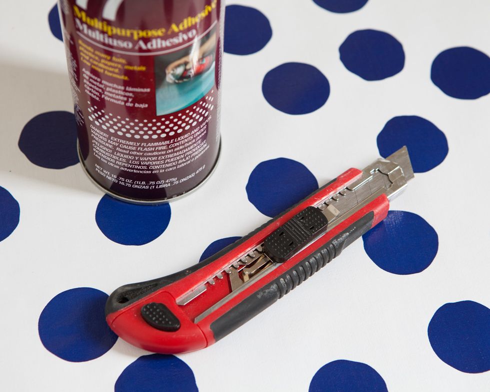 Remove paper and spray back with spray glue. Wait 1-2 minutes for glue to get tacky. Line up paper along one edge of table and slowly roll the paper over the table smoothing with your hands.