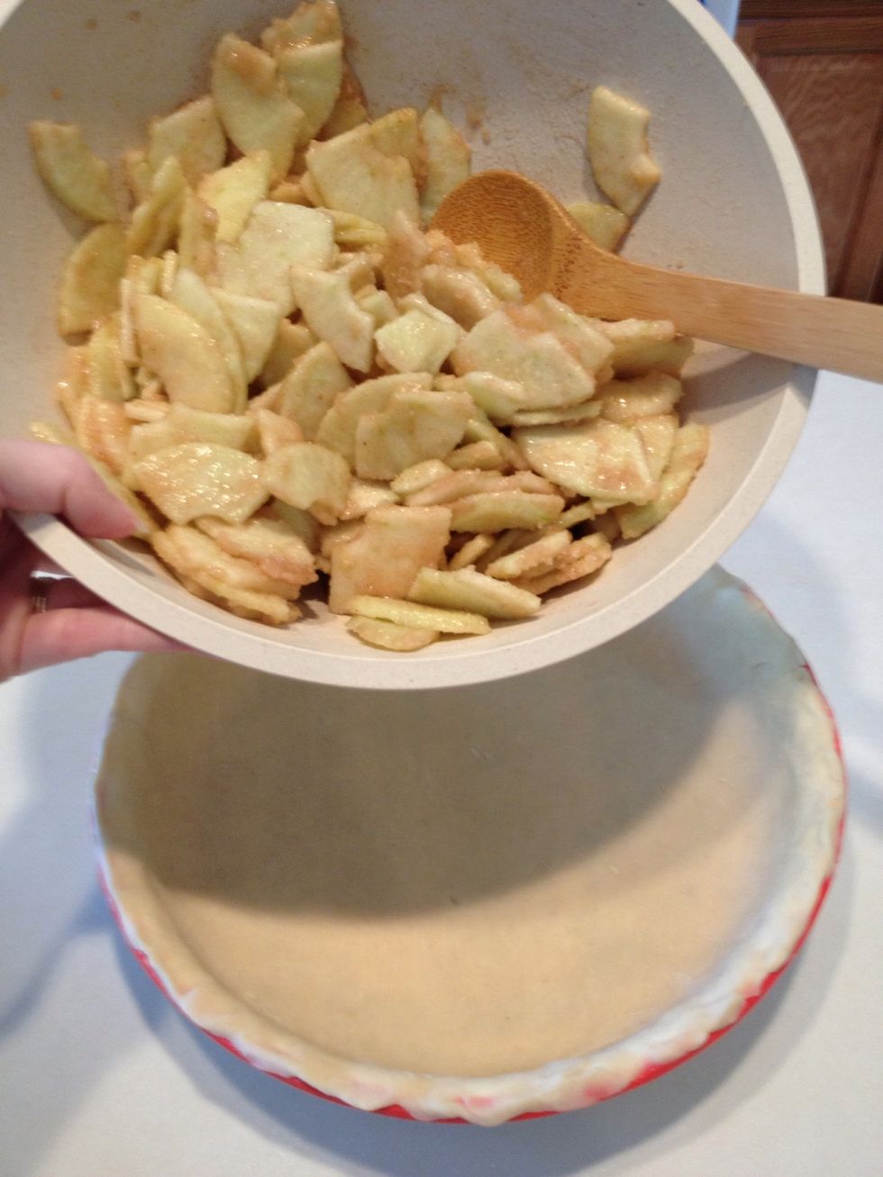 Remove pie crust from refrigerator. Add apples.
