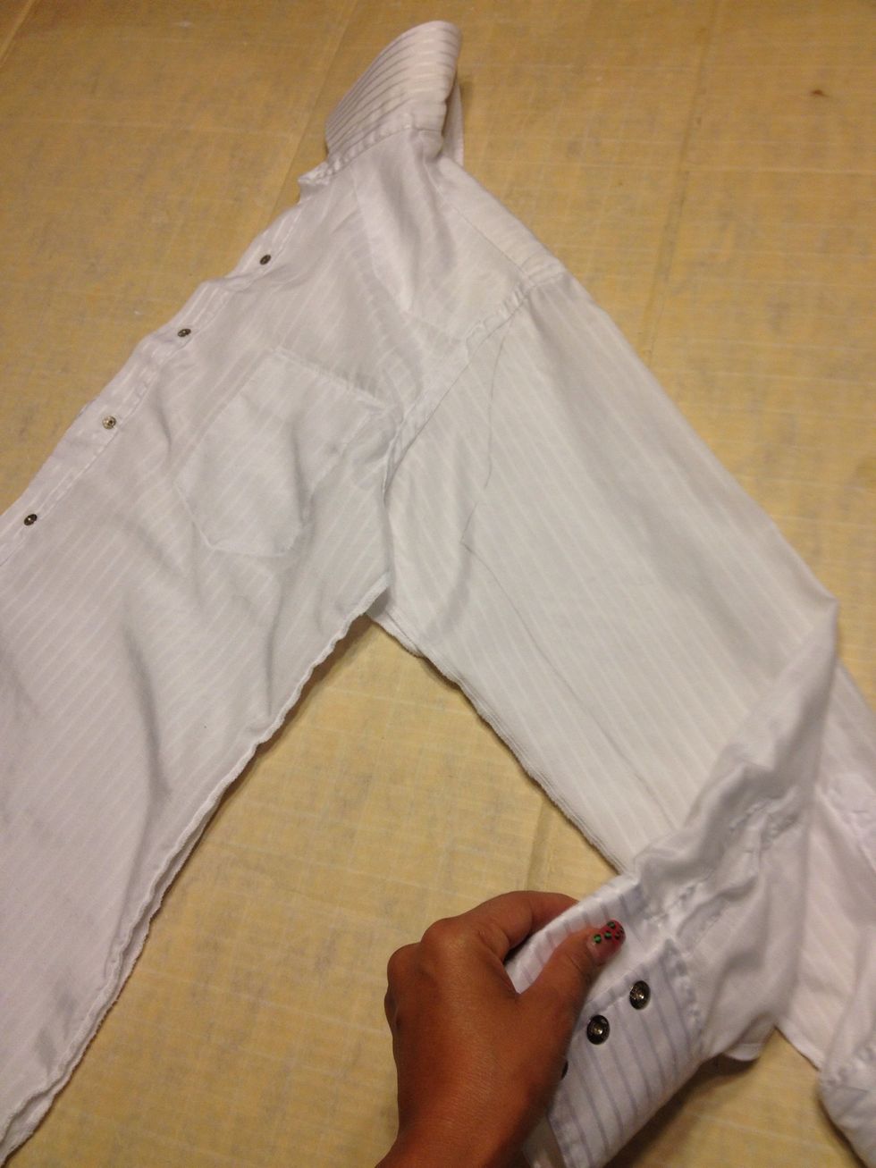 Remove pink shirt. Make sure both sleeves are smooth and flat.