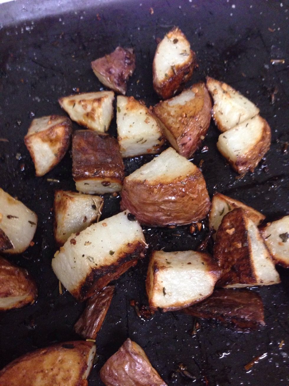 Remove potatoes from oven an set aside to finish cooking the sausage.
