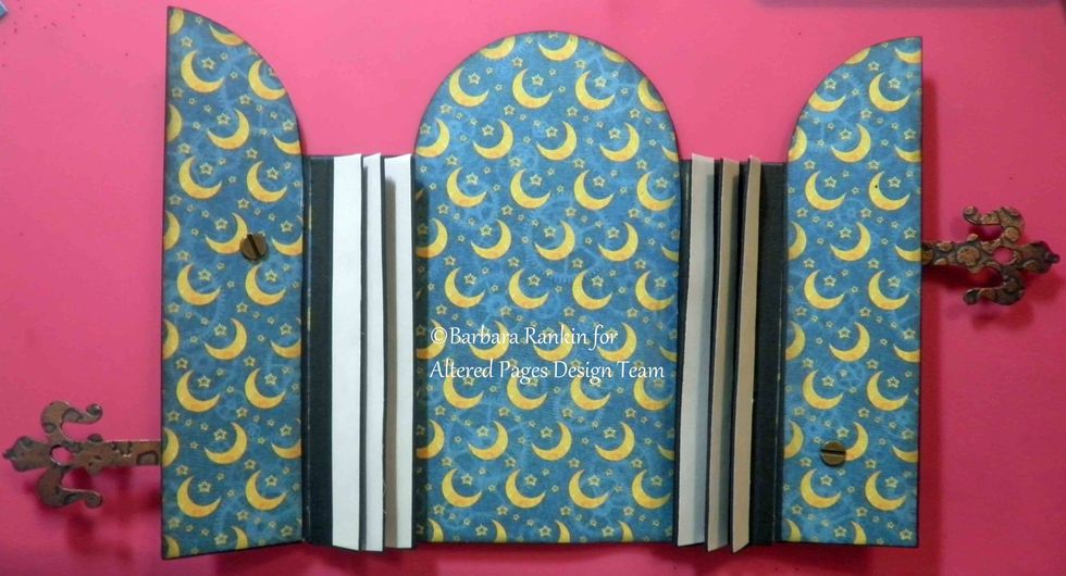 Remove remaining \u00bc" strips and adhere hinges down over inside spine pieces, covering brad prongs. Next, apply \u00bd" strips of Scor-tape along the three tabs, as shown.