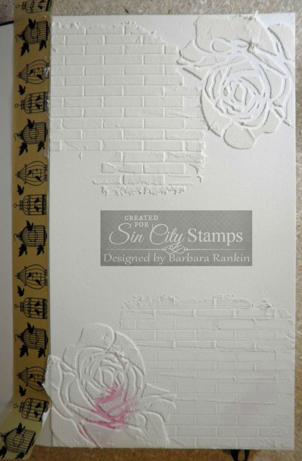 Remove rose mask, align rose stencil and apply light molding paste at bottom left and upper right, as shown. I did not use a mask for the upper right rose but simply moved it around to fit the space.