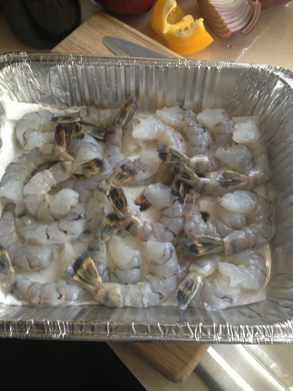 Remove shell, but leave tail shell on (makes it easier to grab when eating :)