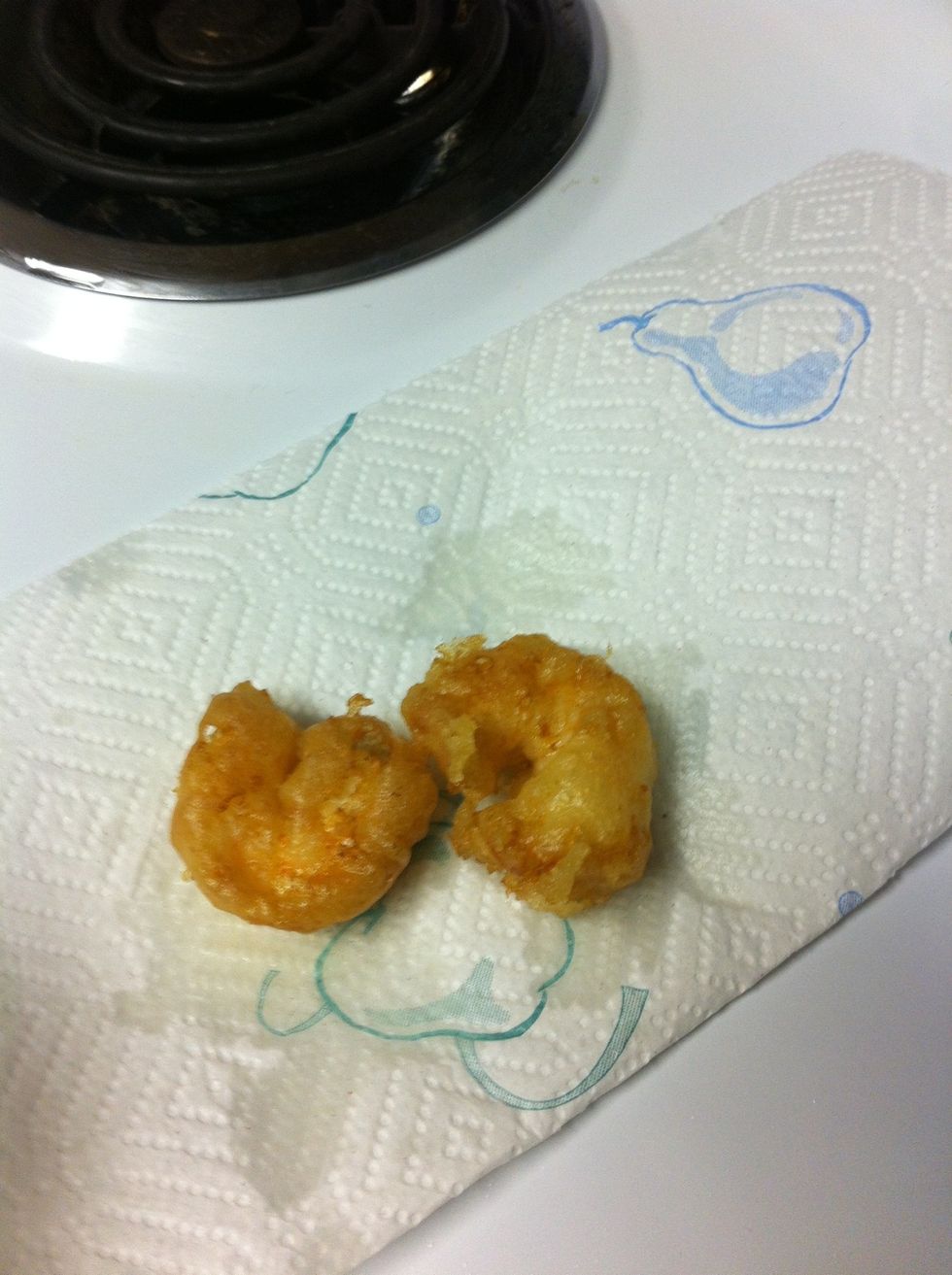 Remove shrimp with tongs or slotted metal spoon and place shrimp on paper towel. Salt shrimp while oil is hot and glistening on batter so it sticks.