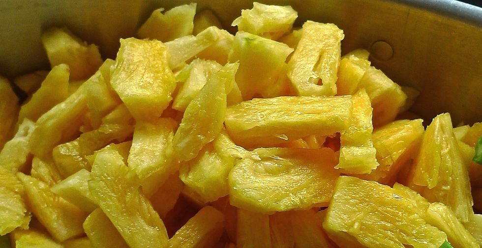 Remove skin and cut pineapple into small pieces.