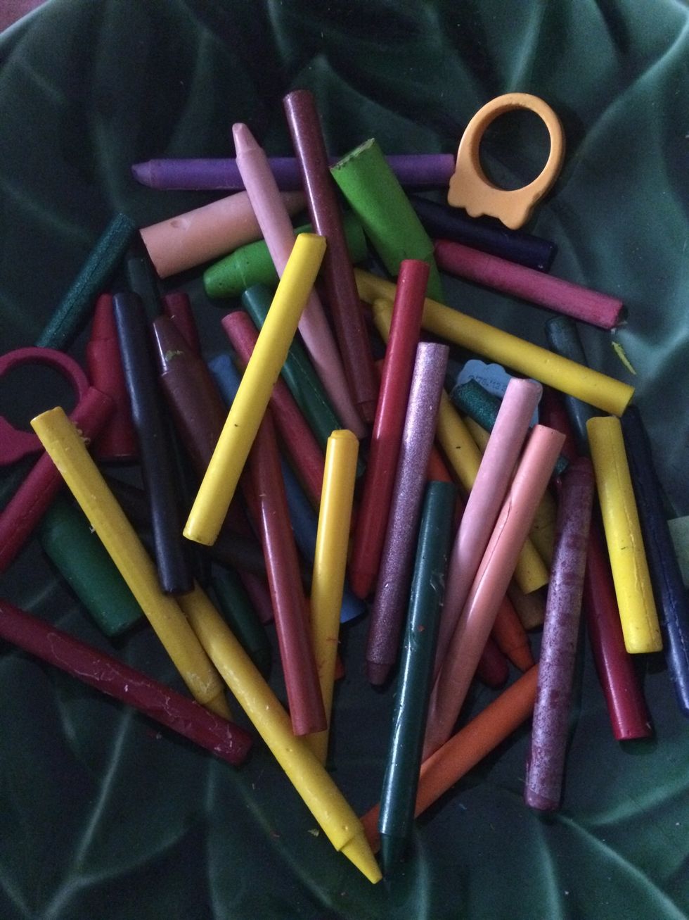 Remove skin--as my daughter calls it! This can be done by hand peeling, using a knife & cutting the paper off, or by placing crayons in a glass bowl & pouring hot water on them. HOT not BOILING!