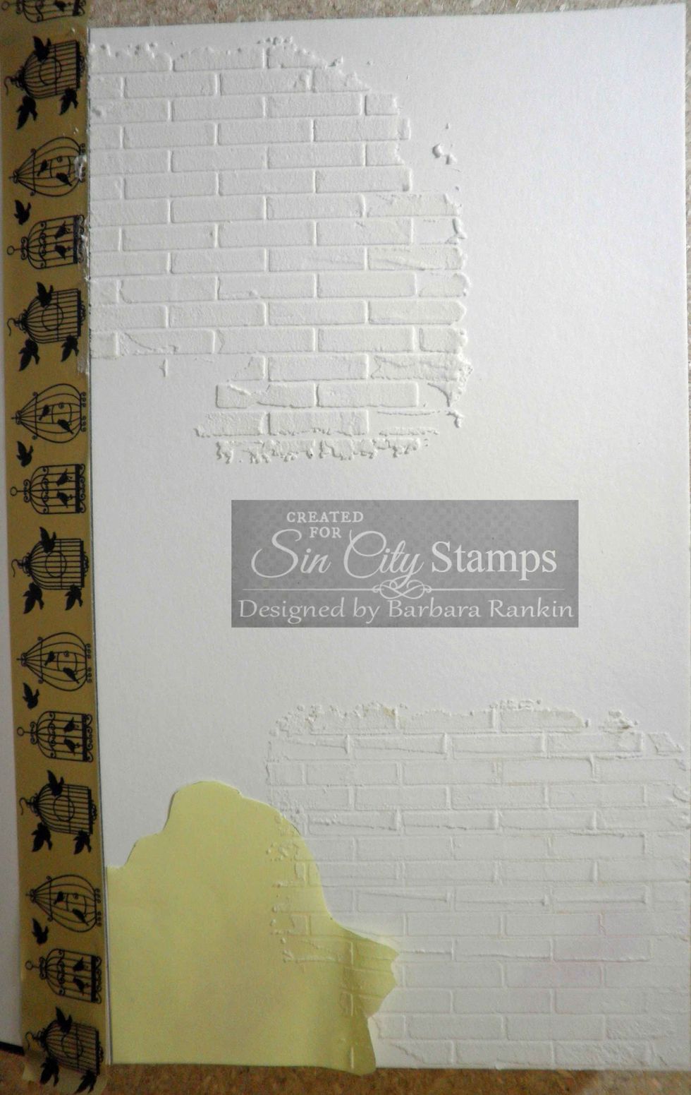 Remove stencil and apply more molding paste through brick stencil at top left.