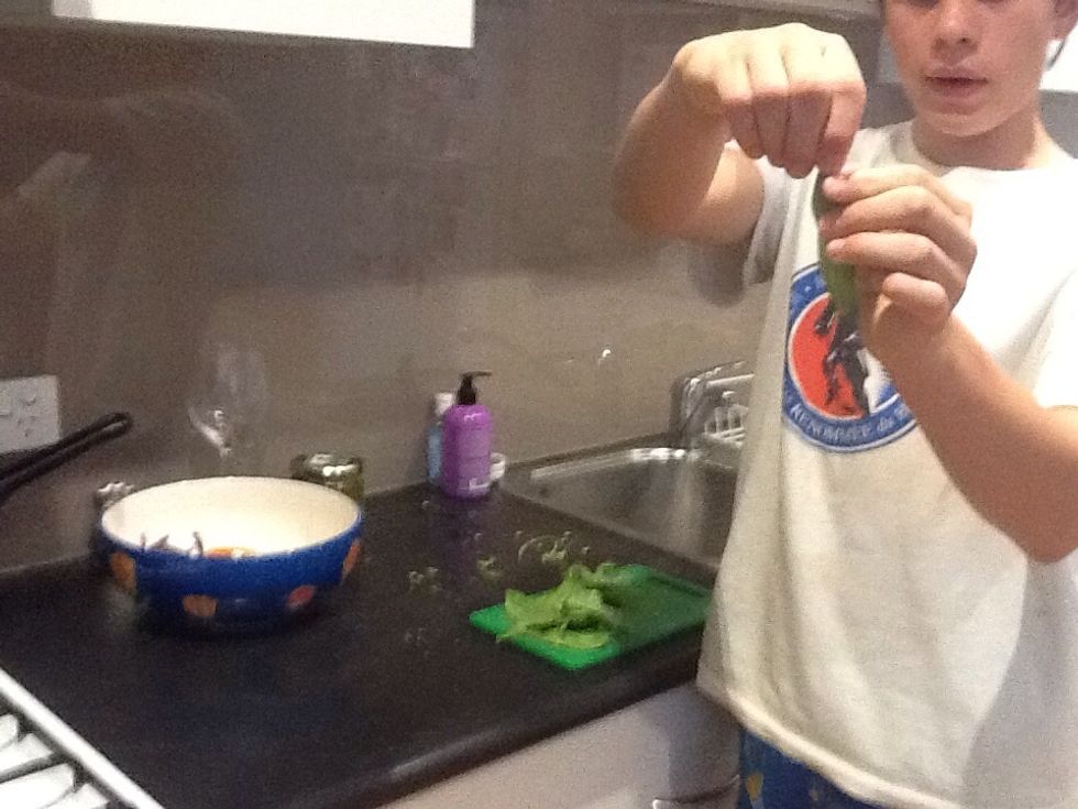 Remove stringy part of snow pea and cut the large ones in half