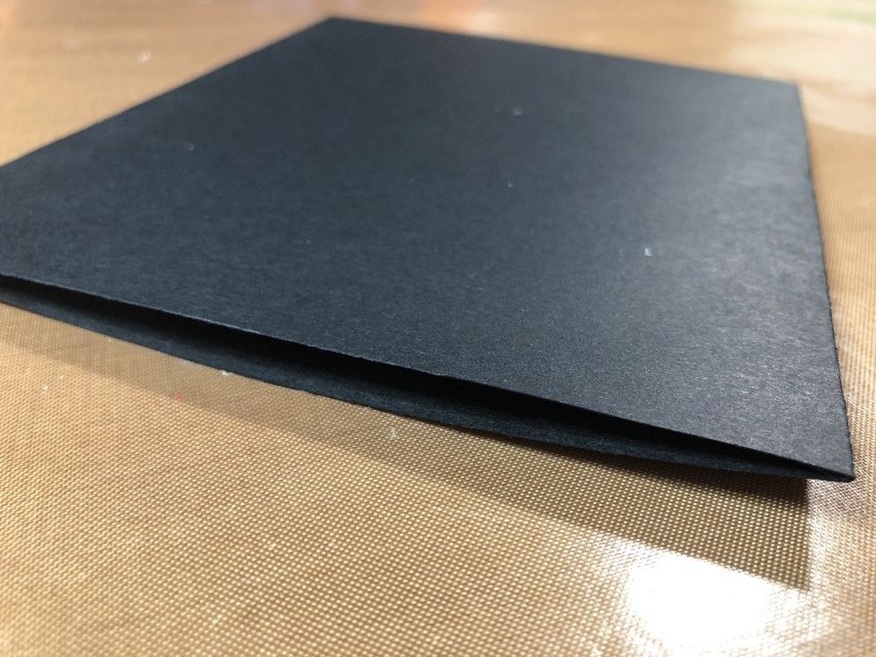 Remove tape backings. Fold closed to create a pocket.
