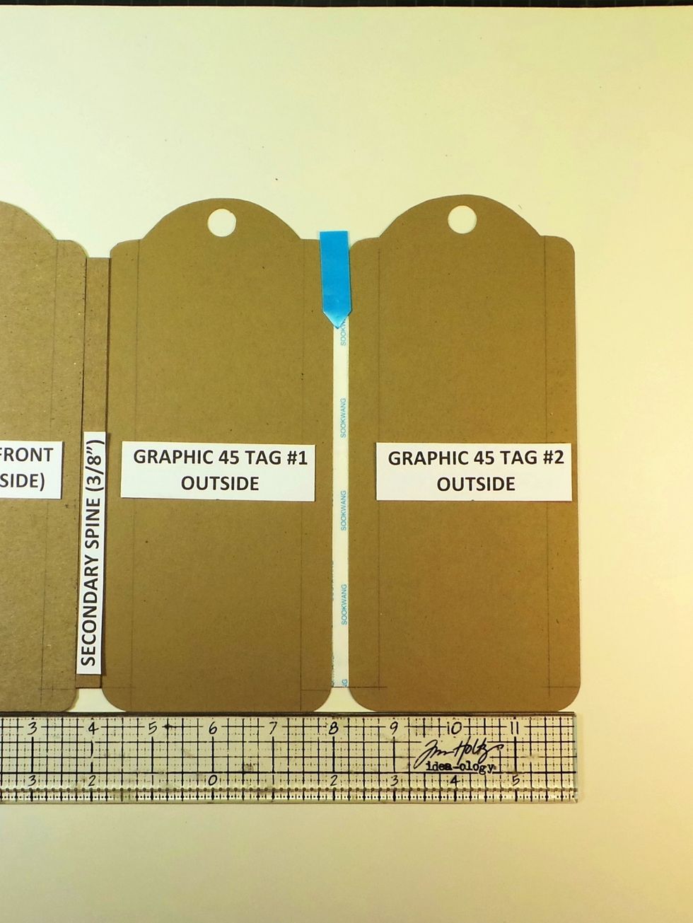 Remove the backing from the 1/2" Scor-Tape on the edge. Leave a 1/4" gap between the two G45 tags. The 1/4" Scor-Tape is a good guide (blue arrow). DON'T REMOVE the backing yet from 1/4" strip.