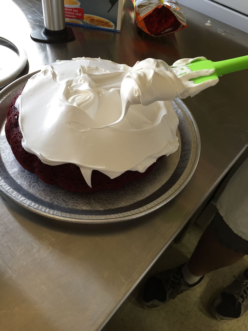 Remove the Baked Alaska from the freezer and cover the cake with a thick coating of meringue, swirling and spiking as you like.