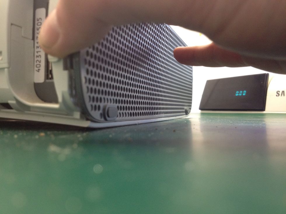 Remove the bottom plastic grey vent. Pull from the front edge in one quick motion.