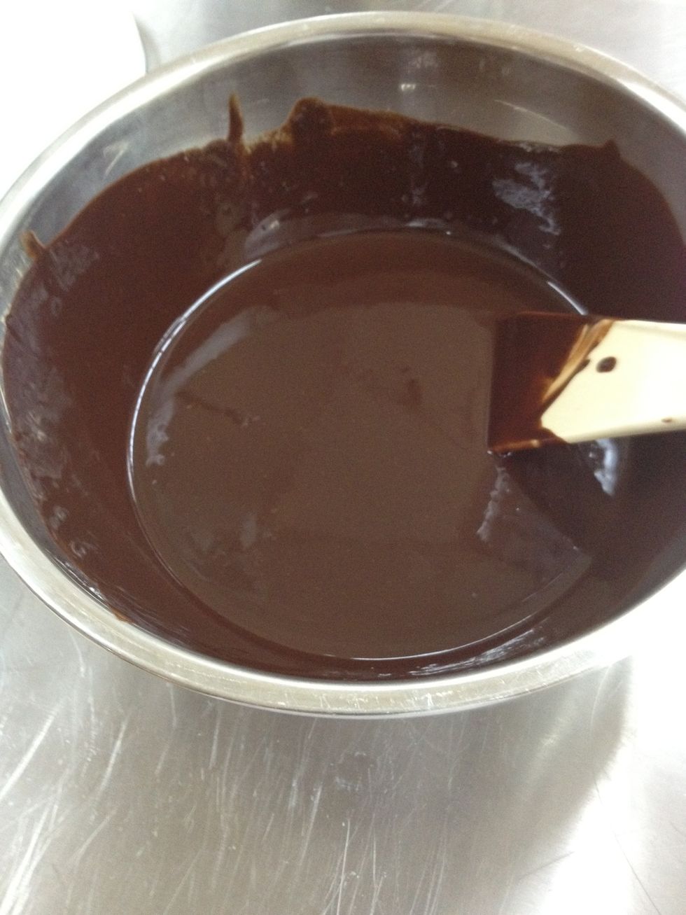 Remove the bowl from heat once the chocolate has fully melted. It's ok if the butter hasn't fully melted. Just continue whisking after you've taken it off the heat, the residual heat melts the butter.