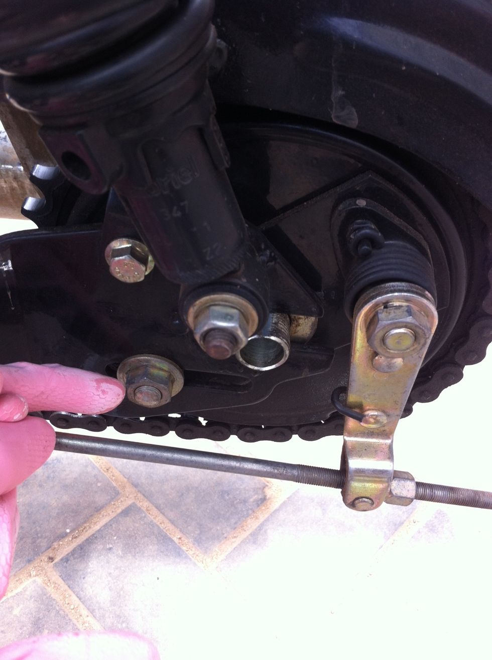 Remove the brake shoe housing stay nut using a 18mm spanner.