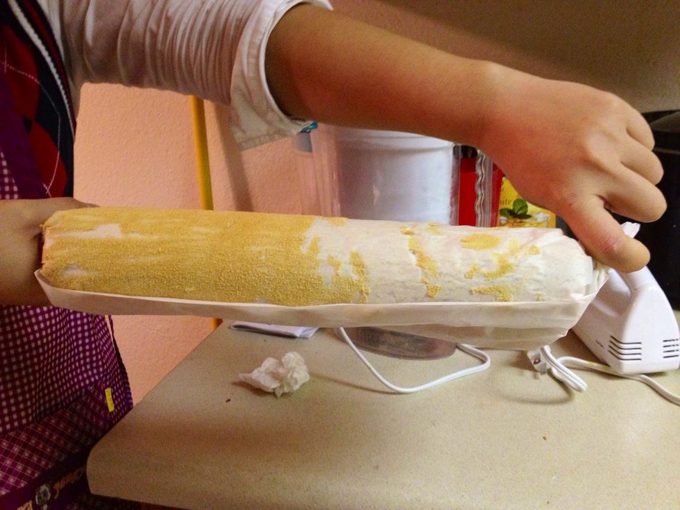 Remove the cake from pan onto towel and start with a short side of the cake, roll up the towel and the warm cake together into a spiral. Refrigerate for one hour.